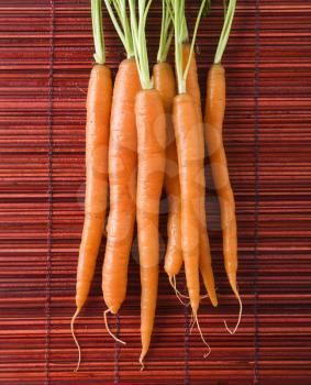 Royalty Free Photo of Carrots on a Bamboo Mat