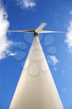 Royalty Free Photo of a Wind Turbine Against a Blue Sky and Clouds