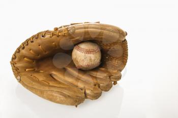 Baseball resting in baseball glove.