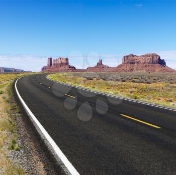 Royalty Free Photo of a Road in Scenic Desert Landscape With Mesa and Mountains