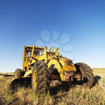 Royalty Free Photo of a Yellow Tractor in a Field