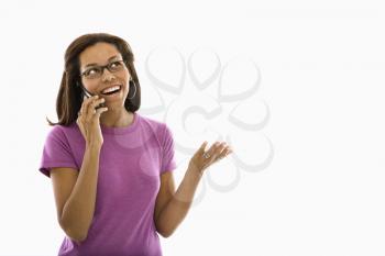 Royalty Free Photo of a Woman Wearing Glasses Gesturing While Talking on a Cellphone