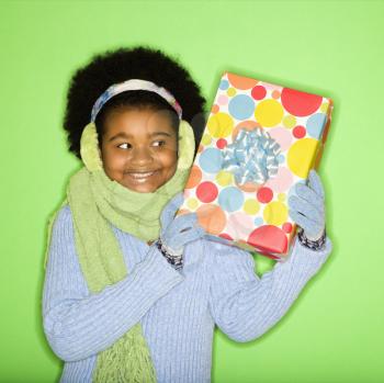Royalty Free Photo of a Smiling Girl Holding a Present