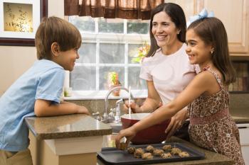 Royalty Free Photo of a Mother and Children Baking Cookies