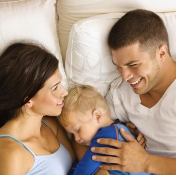 Royalty Free Photo of a Family Cuddling in Bed Together