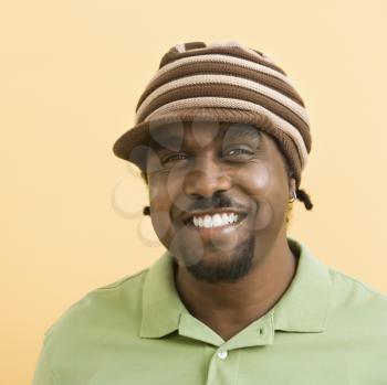 Royalty Free Photo of a Man Wearing a Knit Hat Smiling