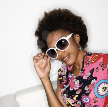 Royalty Free Photo of a Woman With an Afro Wearing a Vintage Print Fabric and Sunglasses