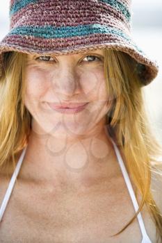 Royalty Free Photo of a Smiling Young Woman Wearing a Hat and Bikini Top