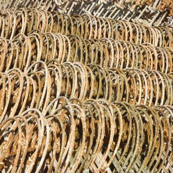 Metal fencing stacked in a row.