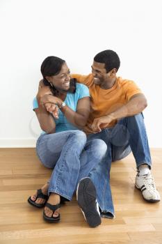 Royalty Free Photo of a Couple Sitting on the Floor Laughing