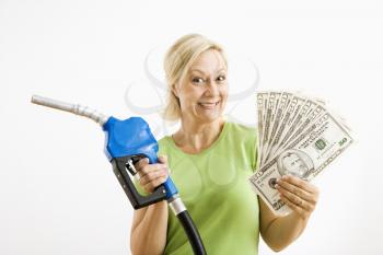 Royalty Free Photo of a Woman Holding a Gas Nozzle and Money