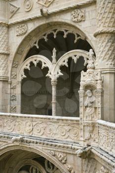 Arched ornate relief and statuary at the Monastery of Jeronimos in Lisbon, Portugal. Vertical shot.