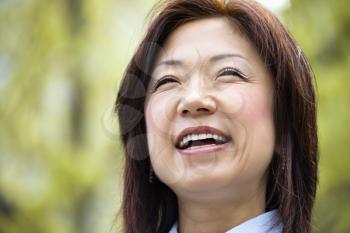Portrait of smiling Asian woman.