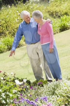 Royalty Free Photo of a Senior Couple in a Flower Garden