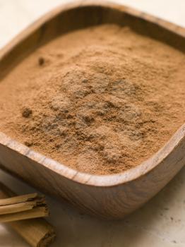 Royalty Free Photo of Ground Cinnamon Powder with Cinnamon Bark