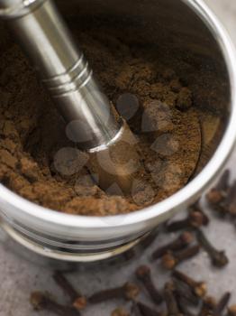 Royalty Free Photo of a Ground Clove Powder in a Pestle and Mortar