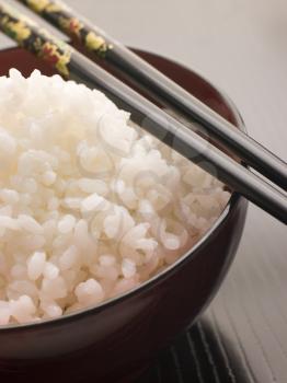 Royalty Free Photo of a Bowl of Koshihikari Rice With Chopsticks