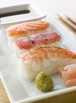 Royalty Free Photo of Hand Molded Seafood Sushi Wasabi Soy Sauce and Sushi Ginger