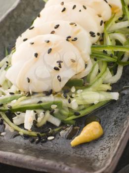 Royalty Free Photo of Sashimi of Dive Scallops Cucumber Mouli and Sesame Salad