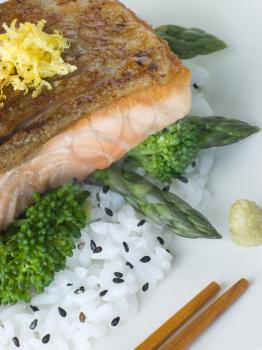 Royalty Free Photo of Citrus Salmon Fillet on Rice Steamed Vegetables With Sesame and Wasabi