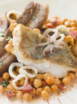 Royalty Free Photo of Pan Fried Cod Fillet and Baby Squid with Braised Belly Pork and Chick Peas
