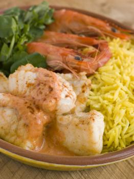 Royalty Free Photo of Saut of Monkfish Prawns and Rice with Pimento Cream