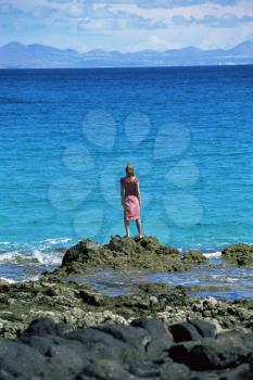 Royalty Free Photo of a Woman Standing at the Shoreline