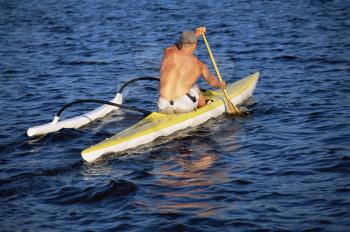 Royalty Free Photo of a Kayaker Rowing in Calm Water