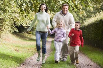 Royalty Free Photo of a Family Running on a Path