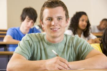 Royalty Free Photo of a Student in Class Taking Notes