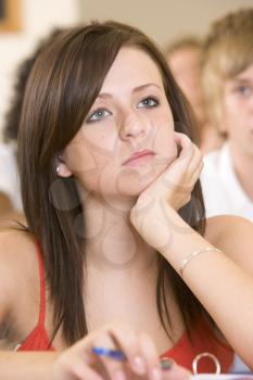 Royalty Free Photo of a Girl in Class Looking Bored