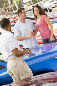 Royalty Free Photo of a Couple Shopping for a Car