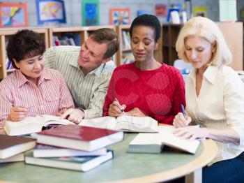 Royalty Free Photo of Three Women and a Man in a Library