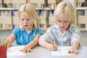 Royalty Free Photo of Two Students Writing