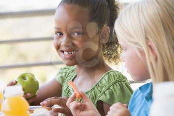 Royalty Free Photo of Two Girls Eating Lunch