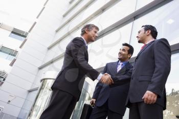 Royalty Free Photo of Three Men Outside a Building