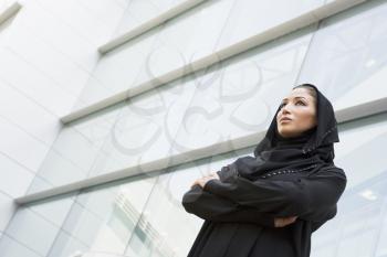 Royalty Free Photo of an Eastern Woman Standing Outside a Building