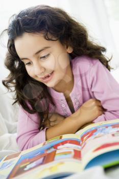 Royalty Free Photo of a Young Girl Reading a Book