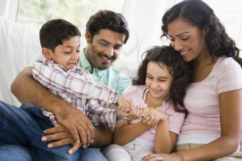 Royalty Free Photo of a Family With the Children Fighting Over the Remote Control