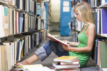 Royalty Free Photo of a Girl on the Library Floor