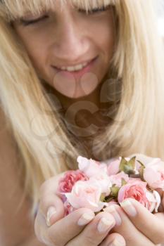 Royalty Free Photo of a Woman Holding a Handful of Roses