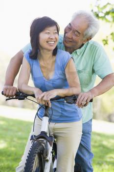 Royalty Free Photo of a Couple Riding a Bike