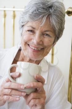 Royalty Free Photo of a Woman in Bed With Coffee