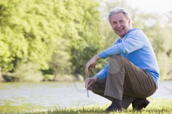 Royalty Free Photo of a Man Beside a Lake