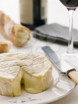 Royalty Free Photo of a Round of Camembert cheese With French Stick and Red Wine