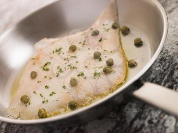 Royalty Free Photo of Pan Fried Wing of Skate with Caper Butter