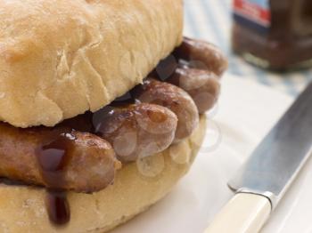 Royalty Free Photo of Pork Sausage Crusty Roll With Brown Sauce