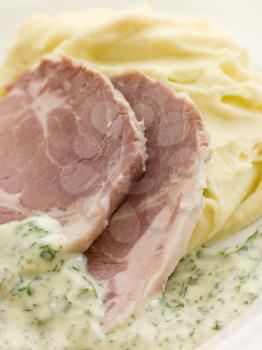 Royalty Free Photo of Boiled Collar of Bacon with Mashed Potato and Parsley Sauce