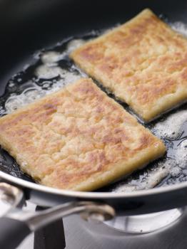 Royalty Free Photo of Potato Farls Frying in Butter