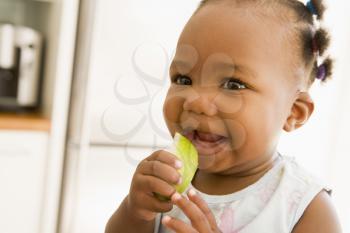 Royalty Free Photo of a Little Girl Eating an Apple
